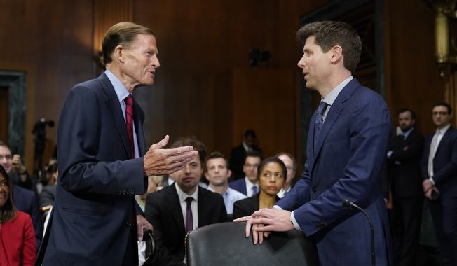 Sen. Richard Blumenthal, D-Conn., left, chair of the Senate Judiciary Subcommittee on Privacy, Technology and the Law, speaks with OpenAI CEO Sam Altman before a hearing on artificial intelligence, Tuesday, May 16, 2023, on Capitol Hill in Washington. (AP Photo/Patrick Semansky)
