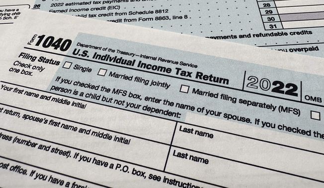 The Internal Revenue Service 1040 tax form for 2022 is seen on April 17, 2023. The IRS is planning to launch a pilot program for a government-run, online tax filing system that’s free for all. After months of research, the IRS published a feasibility report on Tuesday, May 16, 2023, laying out taxpayer interest in direct file, how the system could work, its potential cost, operational challenges and more. (AP Photo/Jon Elswick, File)