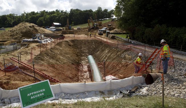 Construction crews are boring beneath U.S. 221 in Roanoke County, Va., to make a tunnel through which the Mountain Valley Pipeline will pass under the highway, seen on Friday, June 22, 2018. The U.S. Forest Service has reissued approval for the controversial and long-delayed natural gas pipeline to run through Jefferson National Forest in Virginia and West Virginia. The decision Monday, May 15, 2023, will allow for the construction of the $6.6 billion Mountain Valley Pipeline across a 3.5-mile corridor of the national forest. (Heather Rousseau/The Roanoke Times via AP, File)