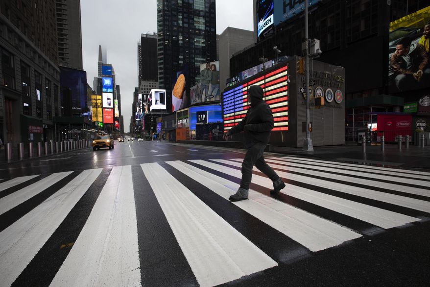A man crosses the street in a nearly empty Times Square, devoid of the usual weekday morning crowds, March 23, 2020, in New York. In May 2023, U.S. Surgeon General Vivek Murthy declared loneliness an American epidemic. While solitude and isolation do not automatically equal loneliness, Murthy’s report found, people tightened their groups of friends and cut time spent with them during the pandemic. According to the report, Americans spent 20 minutes a day with friends in 2020 — down from an hour daily two decades ago. (AP Photo/Mark Lennihan) **FILE**