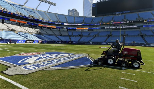 Crews prepare the field at Bank of America Stadium for the Atlantic Coast Conference championship NCAA college football game, Friday, Dec. 1, 2017. The Atlantic Coast Conference has wrapped up its spring meetings. Many discussions were held in private, including talks over how the league plans to close the financial gap with the Big Ten and the Southeastern Conference. (Diedra Laird//The Charlotte Observer via AP, File)