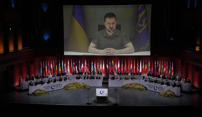 Ukraine&#x27;s President Volodymyr Zelenskyy addresses, via videolink, the opening ceremony of the Council of Europe summit in Reykjavik, Iceland, Tuesday, May 16, 2023. Leaders from across the continent are laser-focused on holding Russia to account for its invasion of Ukraine and were poised to approve a system during their Council of Europe summit that would precisely establish the damages Moscow would have to pay to rebuild the nation. (AP Photo/Alastair Grant, Pool)