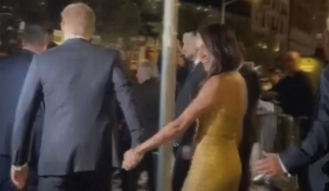 In this image from video, Prince Harry and his wife  Meghan Markle exit Manhattan’s Ziegfeld Ballroom on Tuesday, May 16, 2023 in New York.  The couple’s office says the pair and Meghan’s mother were followed by vehicles after leaving a charity event on Tuesday. It said in a statement Wednesday that the pursuit “resulted in multiple near collisions involving other drivers on the road, pedestrians and two NYPD officers.” The incident instantly drew comparisons to the 1997 fatal car crash of Harry’s mother, Princess Diana. (AP Photo)