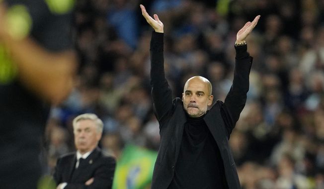 Manchester City&#x27;s head coach Pep Guardiola applauds during the Champions League semifinal second leg soccer match between Manchester City and Real Madrid at Etihad stadium in Manchester, England, Wednesday, May 17, 2023. (AP Photo/Jon Super)