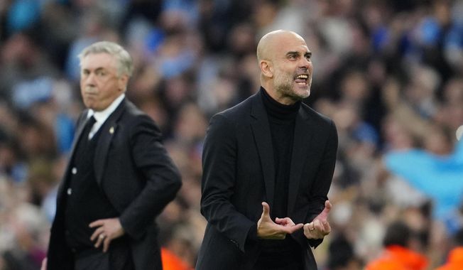 Manchester City&#x27;s head coach Pep Guardiola reacts after Bernardo Silva scored the opening goal during the Champions League semifinal second leg soccer match between Manchester City and Real Madrid at Etihad stadium in Manchester, England, Wednesday, May 17, 2023. (AP Photo/Jon Super)
