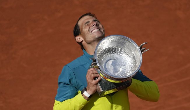 Spain&#x27;s Rafael Nadal lifts the trophy after winning the final match against Norway&#x27;s Casper Ruud in three sets, 6-3, 6-3, 6-0, at the French Open tennis tournament in Roland Garros stadium in Paris, France, Sunday, June 5, 2022. Rafael Nadal will hold a news conference at his tennis academy in Spain on Thursday, May 18, 2023, amid media reports that he is going to miss the French Open for the first time since he won the first of his record 14 titles there on his debut in 2005. Nadal has been sidelined by an injured left hip flexor since January, when he lost in the second round of the Australian Open. (AP Photo/Christophe Ena, File)