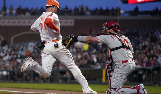 San Francisco Giants&#x27; Joey Bart, left, scores against Philadelphia Phillies catcher J.T. Realmuto during the fourth inning of a baseball game in San Francisco, Tuesday, May 16, 2023. (AP Photo/Jeff Chiu)