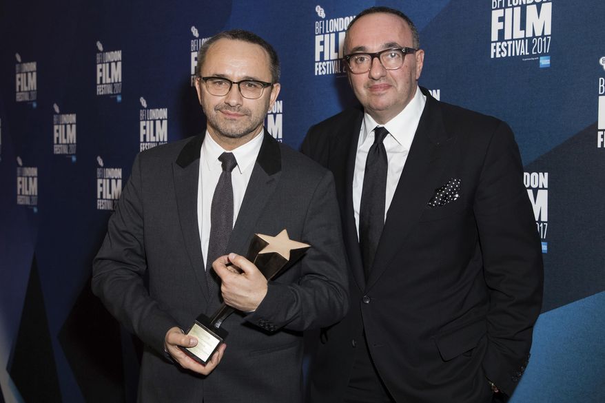 Directors Andrey Zvyagintsev and Alexander Rodnyansky, right, pose for photographers after receiving the Official Competition Best Film award for their film 'Loveless' at the London Film Festival Awards in London, on Oct. 14, 2017. A Moscow court has ordered the arrest of prominent film producer Alexander Rodnyansky and theater director Ivan Vyrypaev for "spreading false information" about the Russian army. (Photo by Vianney Le Caer/Invision/AP, File)
