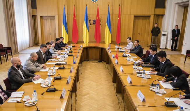In this photo provided by the Ukrainian Foreign Ministry Press Office, Ukrainian Foreign Minister Dmytro Kuleba, center left, and Li Hui, Chinese envoy, center right, during their talks in Kyiv, Ukraine, Wednesday, May 17, 2023. (Ukrainian Foreign Ministry Press Office via AP)