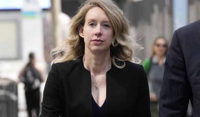 Former Theranos CEO Elizabeth Holmes leaves federal court in San Jose, Calif., March 17, 2023. Holmes has asked a federal judge, Wednesday, May 17, 2023, to allow her to remain free through the Memorial Day weekend before surrendering to authorities on May 30, to begin her more than 11-year prison sentence for defrauding investors in a blood-testing scam. (AP Photo/Jeff Chiu, File)