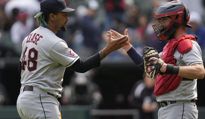 Cleveland Guardians relief pitcher Emmanuel Clase, left, slaps hands with catcher Cam Gallagher after striking out Chicago White Sox&#x27;s Seby Zavala to end the game, Thursday, May 18, 2023, in Chicago. The Guardians won 3-1. (AP Photo/Erin Hooley)