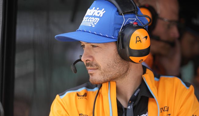 NASCAR&#x27;s Kyle Larson watches practice for the Indianapolis 500 auto race from an Arrow McLaren pit box at Indianapolis Motor Speedway, Thursday, May 18, 2023, in Indianapolis. Larson announced that he will drive in the 2024 Indianapolis 500 for Arrow McLaren. (AP Photo/Darron Cummings)