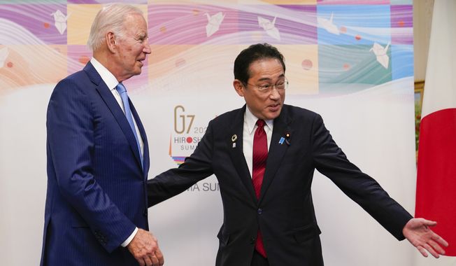 Japan&#x27;s Prime Minister Fumio Kishida gestures to President Joe Biden, left, as they walk to a bilateral meeting in Hiroshima, Japan, Thursday, May 18, 2023, ahead of the start of the G-7 Summit. (AP Photo/Susan Walsh)