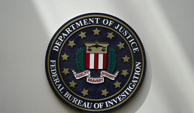 The FBI seal is pictured in Omaha, Neb., Aug. 10, 2022. FBI officials repeatedly violated their own standards when they searched a vast repository of foreign intelligence for information related to the insurrection at the U.S. Capitol on Jan. 6, 2021, and racial justice protests in 2020. That&#x27;s according to a heavily blacked-out court order released Friday, May 19, 2023. FBI officials said the violations predated a series of corrective measures that started in the summer of 2021 and continued last year. (AP Photo/Charlie Neibergall, File)