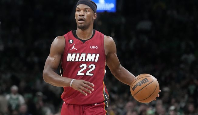 Miami Heat forward Jimmy Butler (22) brings the ball upcourt against the Boston Celtics during the first half of Game 2 of the NBA basketball playoffs Eastern Conference finals in Boston, Friday, May 19, 2023. (AP Photo/Charles Krupa)