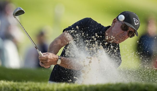 Phil Mickelson hits from the bunker on the seventh hole during the first round of the PGA Championship golf tournament at Oak Hill Country Club on Thursday, May 18, 2023, in Pittsford, N.Y. (AP Photo/Eric Gay)