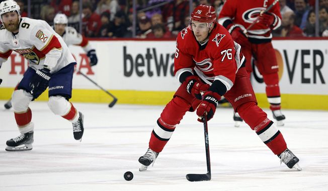 Carolina Hurricanes&#x27; Brady Skjei (76) controls the puck after taking it from Florida Panthers&#x27; Sam Bennett (9) during the first period of Game 1 of the NHL hockey Stanley Cup Eastern Conference finals in Raleigh, N.C., Thursday, May 18, 2023. (AP Photo/Karl B DeBlaker)