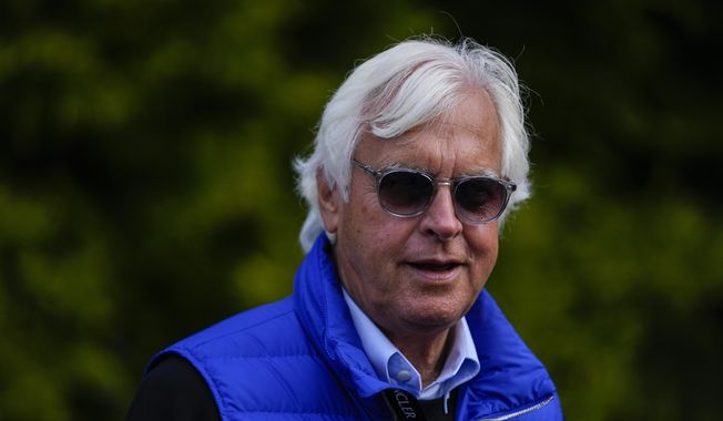 Bob Baffert, center, owner of Preakness Stakes entrant National Treasure, walks near the stables ahead of the 148th running of the Preakness Stakes horse race at Pimlico Race Course, Friday, May 19, 2023, in Baltimore. (AP Photo/Julio Cortez)