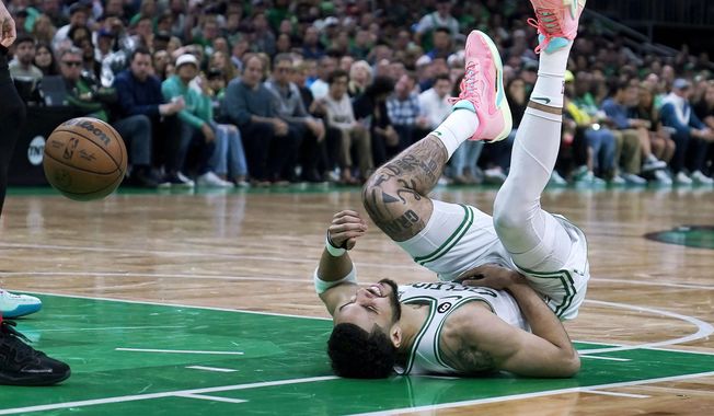 Boston Celtics forward Jayson Tatum reacts on the floor during the second half of Game 2 of the NBA basketball playoffs Eastern Conference finals against the Miami Heat in Boston, Friday, May 19, 2023. (AP Photo/Charles Krupa)