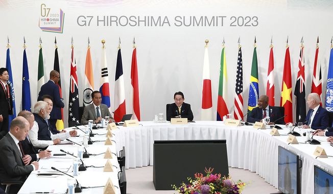 Leaders and delegates, including U.S. President Joe Biden, right, Japan&#x27;s Prime Minister Fumio Kishida, center, Indonesian President Joko Widodo, center left, attend the G7 Outreach Session during the G7 Summit in Hiroshima, Japan, Saturday, May 20, 2023. (Japan Pool via AP)