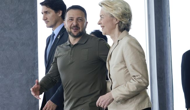 European Commission President Ursula von der Leyen, right, and Ukrainian President Volodymyr Zelenskyy, center, talk as they walk with Canadian Prime Minister Justin Trudeau, left, prior to a working session on Ukraine during the G7 Summit in Hiroshima, western Japan, Sunday, May 21, 2023. (AP Photo/Susan Walsh, POOL)