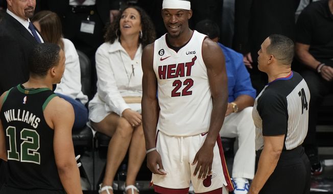 Miami Heat forward Jimmy Butler (22) talks t0 Boston Celtics forward Grant Williams (12) during the second half of Game 3 of the NBA basketball playoffs Eastern Conference finals, Sunday, May 21, 2023, in Miami. (AP Photo/Lynne Sladky)