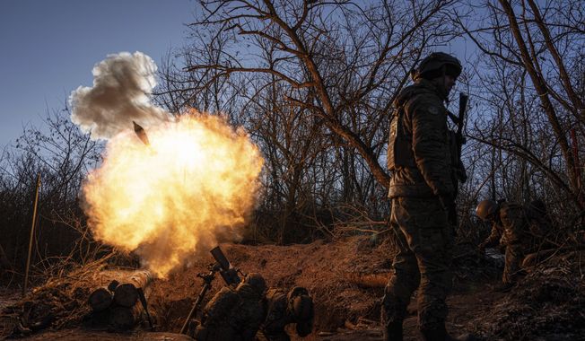Ukrainian servicemen fire a 120mm mortar towards Russian positions at the frontline near Bakhmut, Donetsk region, Ukraine, Wednesday, Jan. 11, 2023. Ukrainian President Volodymyr Zelenskyy said Sunday, May 21, 2023, that Russian forces weren&#x27;t occupying Bakhmut, casting doubt on Moscow&#x27;s insistence that the eastern Ukrainian city had fallen. The fog of war made it impossible to confirm the situation on the ground in the invasion’s longest battle, and the comments from Ukrainian and Russian officials added confusion to the matter. (AP Photo/Evgeniy Maloletka, File)