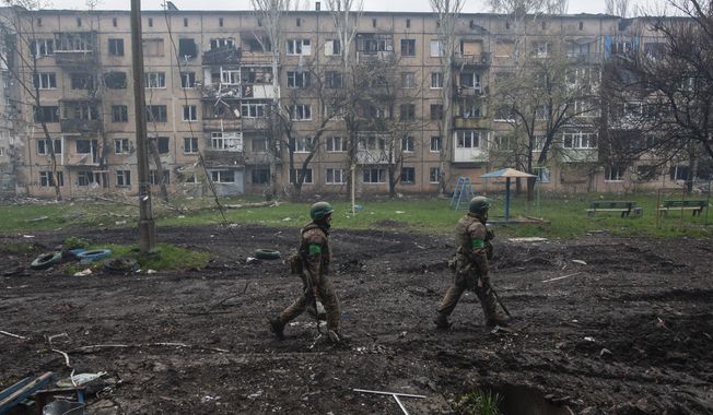 Ukrainian soldiers walk in an area of the heaviest battles in Bakhmut, Donetsk region, Ukraine, Friday, April 21, 2023. Ukrainian President Volodymyr Zelenskyy said Sunday, May 21, 2023 that Russian forces weren&#x27;t occupying Bakhmut, casting doubt on Moscow&#x27;s insistence that the eastern Ukrainian city had fallen. The fog of war made it impossible to confirm the situation on the ground in the invasion’s longest battle, and the comments from Ukrainian and Russian officials added confusion to the matter. (Iryna Rybakova via AP, File)
