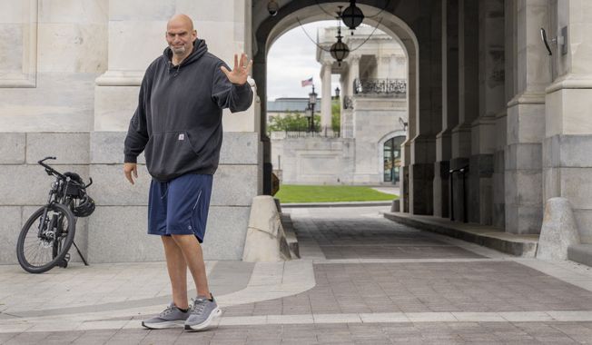 Sen. John Fetterman, D-Penn., waves to members of the media, Monday, April 17, 2023, on Capitol Hill in Washington, as he returns to the Capitol after seeking inpatient treatment for clinical depression. (AP Photo/Jacquelyn Martin, File)