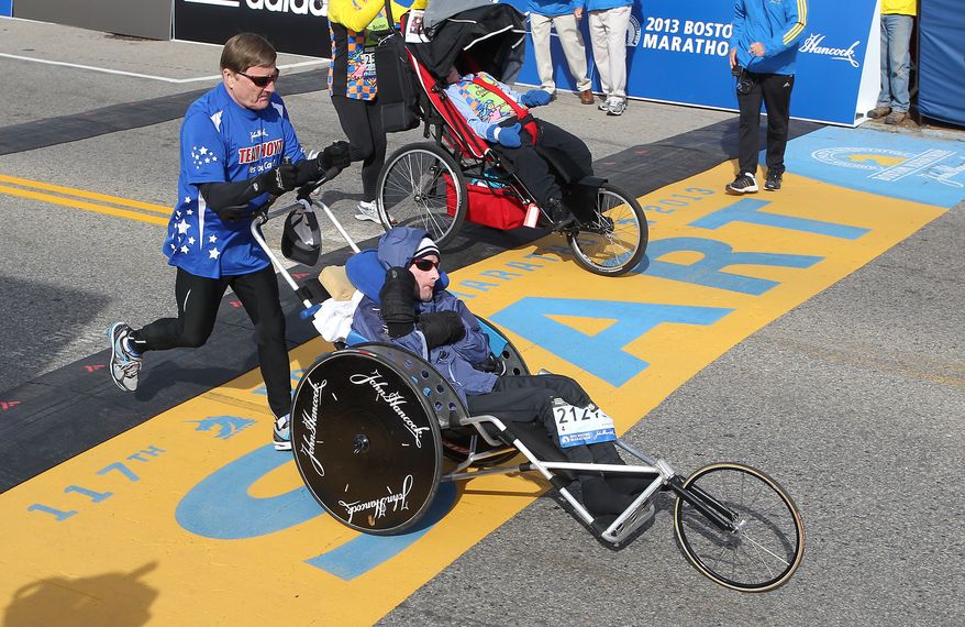 Dick Hoyt, left, and his son, Rick, start of the 117th running of the Boston Marathon, in Hopkinton, Mass., Monday, April 15, 2013. (AP Photo/Stew Milne) **FILE**