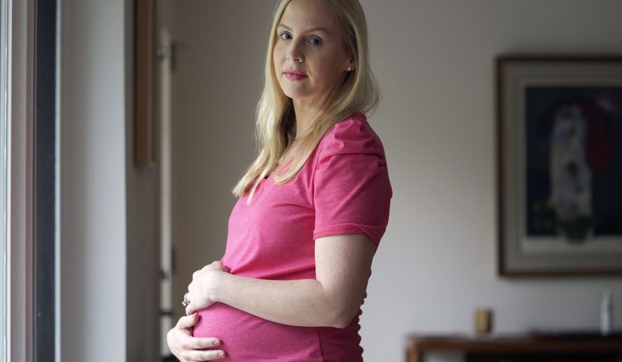 Dr. Austin Dennard poses for a photo at her home in Dallas, Thursday, May 18, 2023. More Texas women who were told they could not end pregnancies with fatal fetal anomalies or that endangered their health are challenging the state's restrictive abortion laws. (AP Photo/LM Otero)