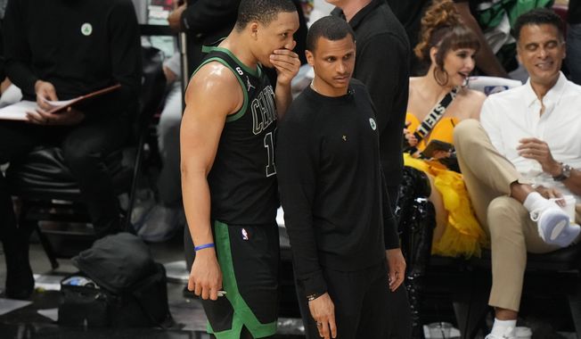 Boston Celtics forward Grant Williams (12) talks to head coach Joe Mazzulla during the second half of Game 3 of the NBA basketball playoffs Eastern Conference finals, Sunday, May 21, 2023, in Miami. (AP Photo/Lynne Sladky)