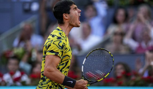 Carlos Alcaraz, of Spain, celebrates a point against Jan-Lennard Struff, of Germany, during their men&#x27;s singles final match at the Madrid Open tennis tournament in Madrid, Spain, Sunday, May 7, 2023. (AP Photo/Manu Fernandez)