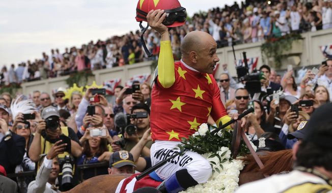 Jockey Mike Smith tips his helmet to the crowd as he rides Justify to the winner&#x27;s circle after winning the 150th running of the Belmont Stakes horse race and Triple Crown on June 9, 2018, in Elmont, N.Y. Earlier in 2023, horse racing was rocked by the deaths less than six weeks apart of two young jockeys, 23-year-old Avery Whisman and 29-year-old Alex Canchari, each of whom killed himself. A friend of Whisman&#x27;s, Triple Crown-winning rider Mike Smith has over three decades seen similar tragedies unfold. (AP Photo/Peter Morgan, File)