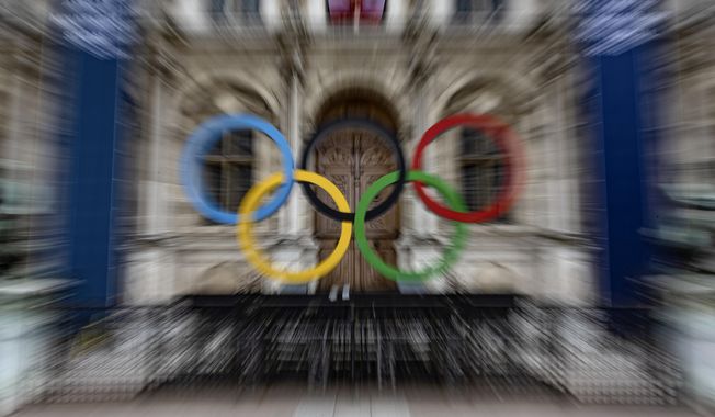 The Olympic rings are seen in front of the Paris City Hall, in Paris, Sunday, April 30, 2023. French security experts have expressed misgivings about size and complexity of the security operation that will be needed to safeguard Paris&#x27; ambitions for the unprecedented opening gala along the River Seine (AP Photo/Aurelien Morissard, File)