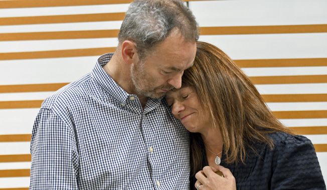 Simon and Sally Glass comfort each other during an emotional news conference in Denver on Tuesday, Sept. 13, 2022. They are calling for accountability after police shot and killed their 22-year-old son, Christian Glass, after he called 911 for roadside assistance in the Colorado mountain town of Silver Plume in June. The Glasses say their son was having a mental health episode and police needlessly escalated the situation. (AP Photo/Thomas Peipert, File)