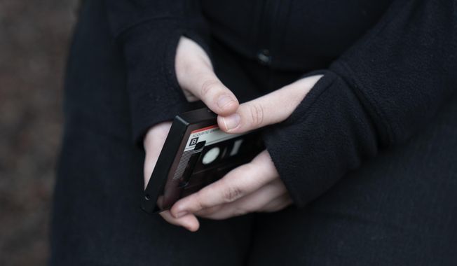 A teenager holds her phone as she sits for a portrait near her home in Illinois, on Friday, March 24, 2023. The U.S. Surgeon General is warning there is not enough evidence to show that social media is safe for young people — and is calling on tech companies, parents and caregivers to take &quot;immediate action to protect kids now.&quot; (AP Photo Erin Hooley, File)
