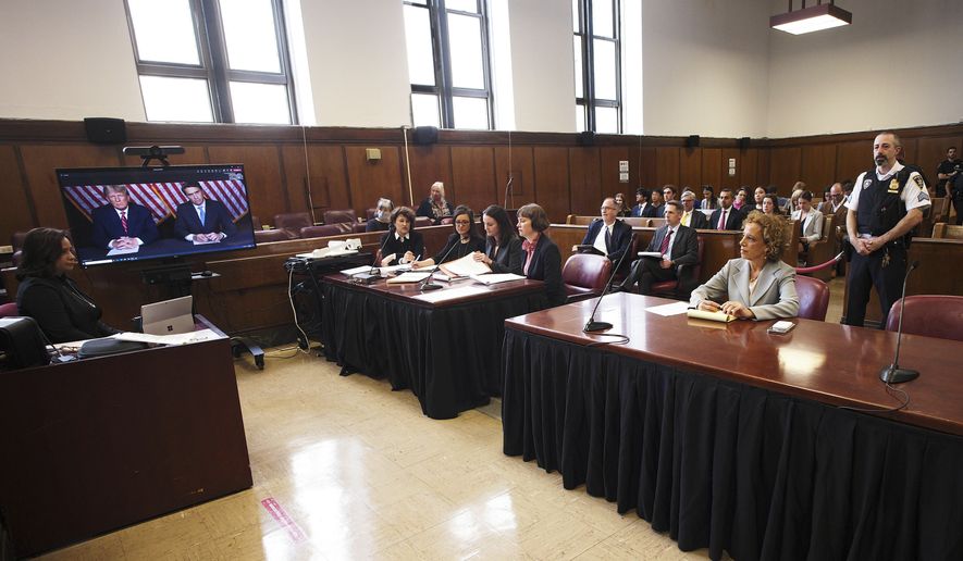 Former president Donald Trump, left on screen, and his attorney, Todd Blanche, right on screen, appear by video, as his other attorney Susan Necheles, right, looks on, before a hearing begins in Manhattan criminal court, in New York, Tuesday, May 23, 2023. Trump made a video appearance Tuesday in his New York criminal case, with the judge tentatively setting a trial date for late March of next year. (AP Photo/Curtis Means via Pool)