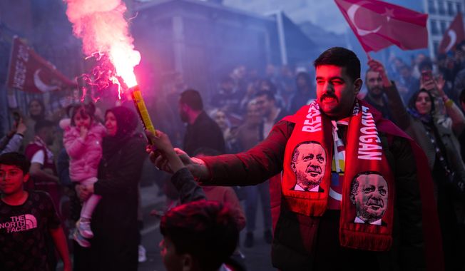 Supporters of Turkish President Recep Tayyip Erdogan cheer outside AKP (Justice and Development Party) headquarters in Istanbul, Turkey, Sunday, May 14, 2023. Turkish President Recep Tayyip Erdogan has remained in power for 20 years by repeatedly surmounting political crises: mass protests, corruption allegations, an attempted military coup and a huge influx of refugees fleeing Syria&#x27;s civil war. Now the Turkish people and economy are being pummeled by sky-high inflation, and many are still recovering from a devastating earthquake in February made worse by the government&#x27;s slow response. (AP Photo/Francisco Seco)