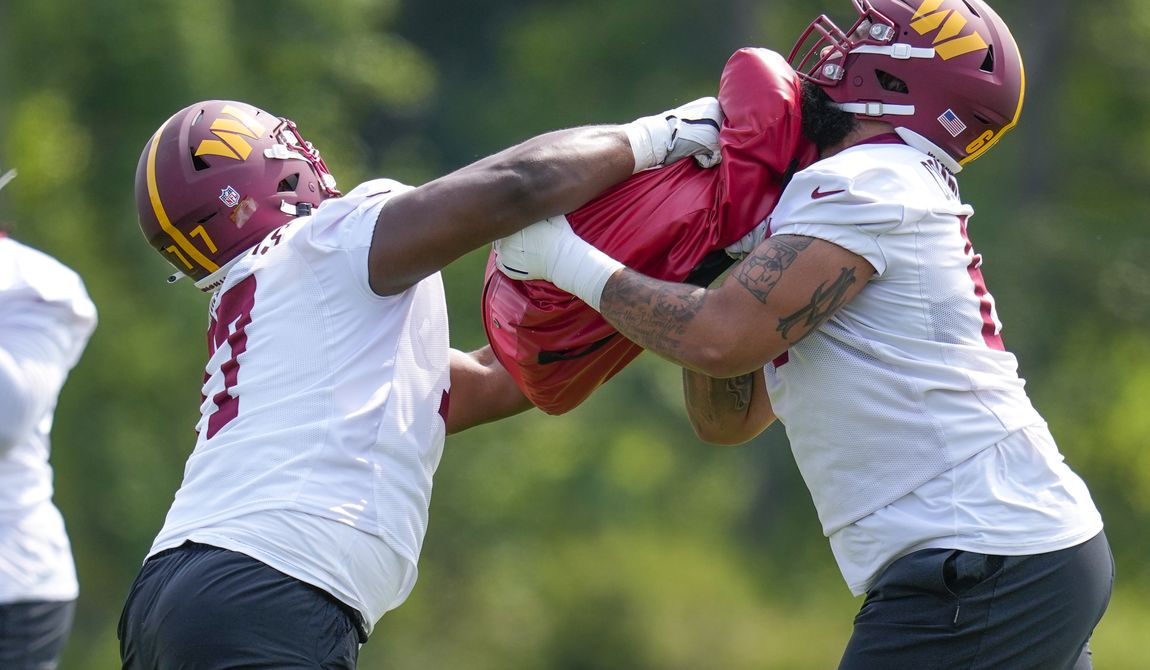 Washington Commanders offensive tackle Saahdiq Charles (77) works against guard Mason Brooks (61) during an NFL football practice at the team&#x27;s training facility, Wednesday, May 24, 2023 in Ashburn, Va. (AP Photo/Alex Brandon)