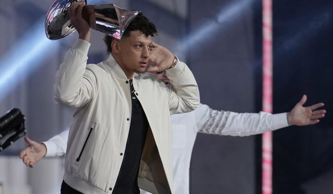 Kansas City Chiefs quarterback Patrick Mahomes holds up the Vince Lombardi Trophy during the first round of the NFL football draft, Thursday, April 27, 2023, in Kansas City, Mo. (AP Photo/Jeff Roberson)