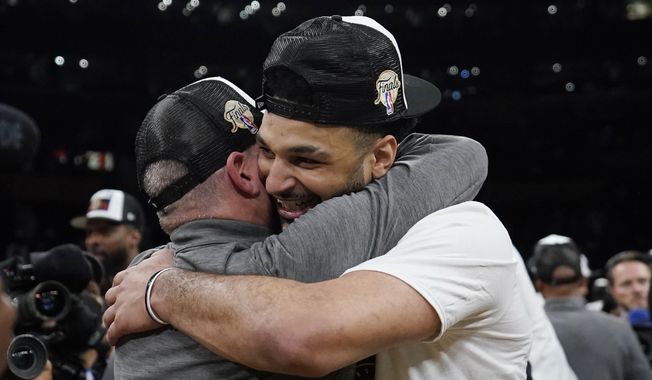 Denver Nuggets guard Jamal Murray, right, is hugged by head coach Michael Malone after Game 4 of the NBA basketball Western Conference Final series against the Los Angeles Lakers Monday, May 22, 2023, in Los Angeles. (AP Photo/Ashley Landis)