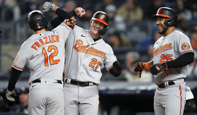 Baltimore Orioles&#x27; Austin Hays (21) and Anthony Santander (25) celebrate with Adam Frazier (12) after Frazier hit a three-run home run against the New York Yankees during the seventh inning of a baseball game Wednesday, May 24, 2023, in New York. (AP Photo/Frank Franklin II)