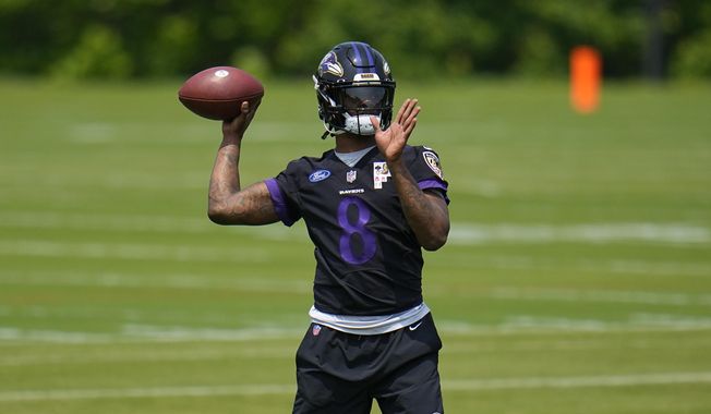 Baltimore Ravens quarterback Lamar Jackson works out during the team&#x27;s NFL football practice, Wednesday, May 24, 2023, in Owings Mills. (AP Photo/Julio Cortez)