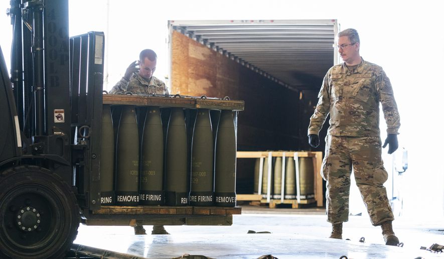 Airmen with the 436th Aerial Port Squadron place 155 mm shells on aircraft pallets ultimately bound for Ukraine, April 29, 2022, at Dover Air Force Base, Del. Half of the people in the U.S. support the Pentagon's ongoing supply of weapons to Ukraine for its defense against Russian forces. That's according to a new survey by the University of Chicago's Harris School of Public Policy and NORC. (AP Photo/Alex Brandon, File)