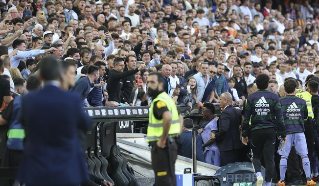 Real Madrid&#x27;s Vinicius Junior, center, leaves the pitch after being shown a red card during a Spanish La Liga soccer match between Valencia and Real Madrid, at the Mestalla stadium in Valencia, Spain, Sunday, May 21, 2023. Repeated racist insults against Real Madrid&#x27;s Brazilian soccer star Vincius Junior have unleashed a heated debate in Spain about tolerance for racism in a society that is becoming rapidly more diverse on and off the field. (AP Photo/Alberto Saiz, File)