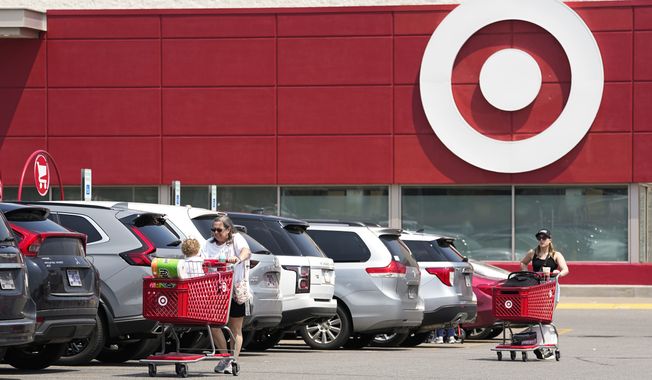 Customers make their way through the parking lot of a Target store Wednesday, May 24, 2023, in Nashville, Tenn. Target is removing certain items from its stores and making other changes to its LGBTQ+ merchandise nationwide ahead of Pride month after an intense backlash from some customers including violent confrontations with its workers. (AP Photo/George Walker IV)