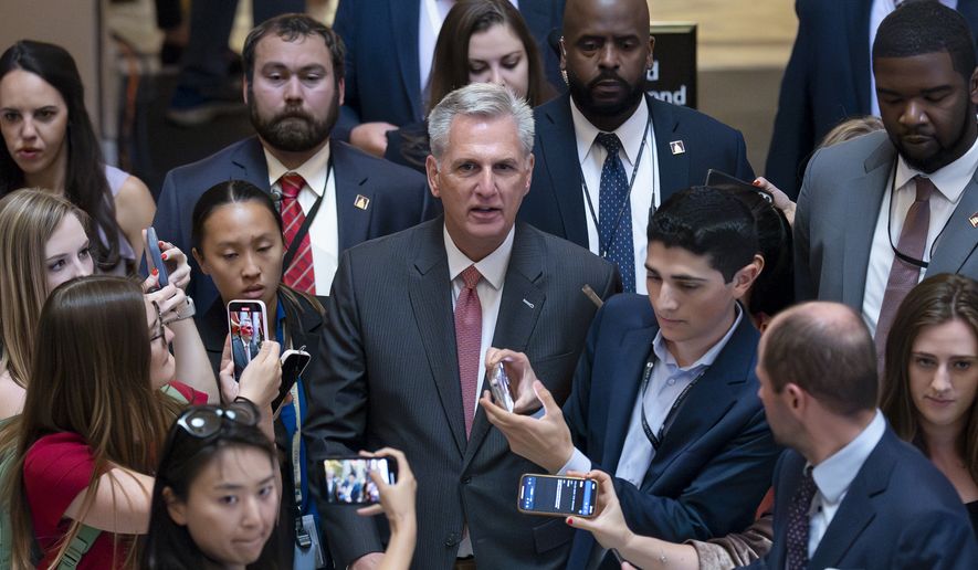 Reporters encircle Speaker of the House Kevin McCarthy, R-Calif., as debt limit negotiations continue, at the Capitol in Washington, Thursday, May 25, 2023. McCarthy adjourned the House for the Memorial Day weekend. (AP Photo/J. Scott Applewhite)