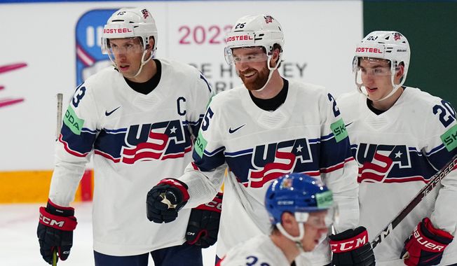 United States Nick Perbix, centre, celebrates with teammates after scoring his side&#x27;s second goal during the quarterfinal match between United States and Czech Republic at the ice hockey world championship in Tampere, Finland, Thursday, May 25, 2023. (AP Photo/Pavel Golovkin)