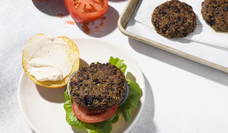 This image released by Milk Street shows a recipe for quinoa and black bean burgers. (Milk Street via AP)